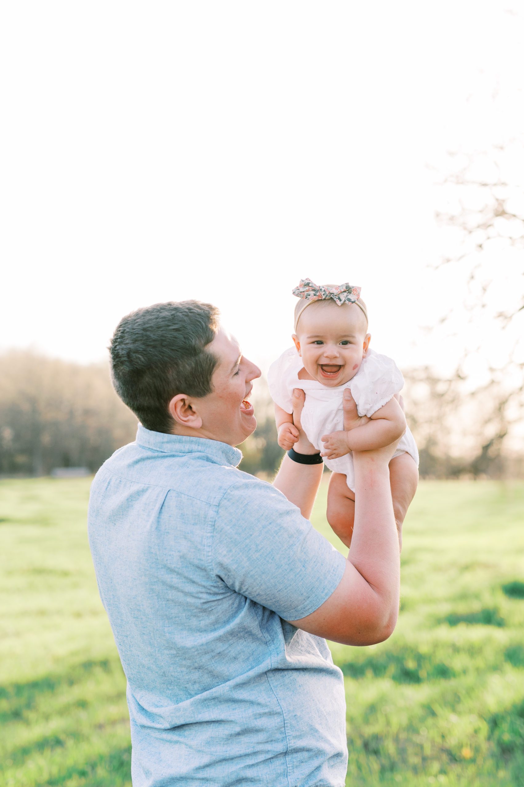 dad and baby girl laughing in Minneapolis field