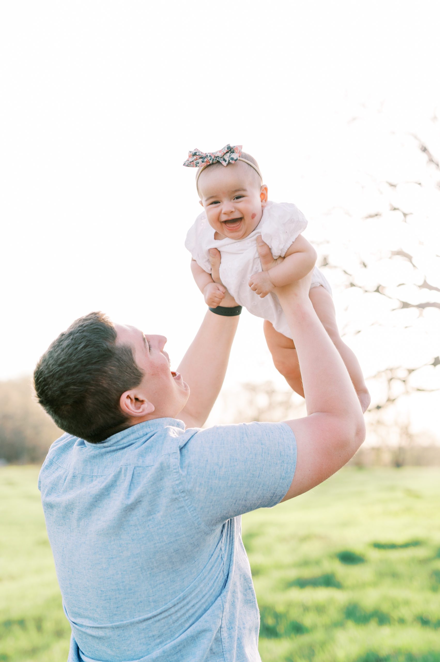dad and baby girl laughing in Minneapolis field