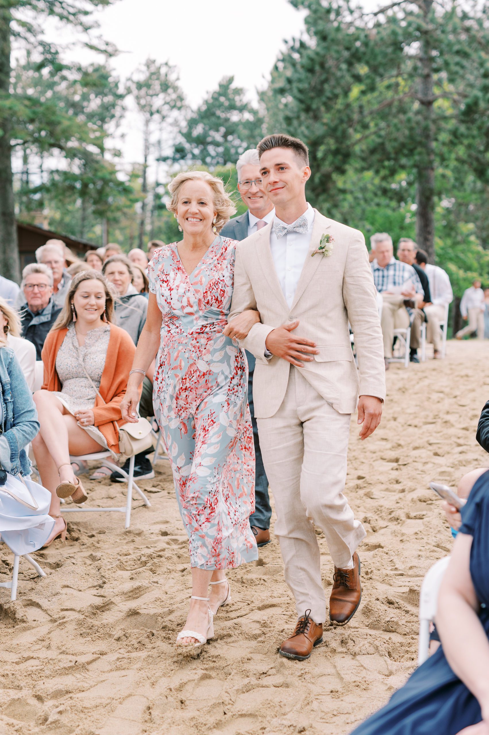 groom coming down aisle with mom