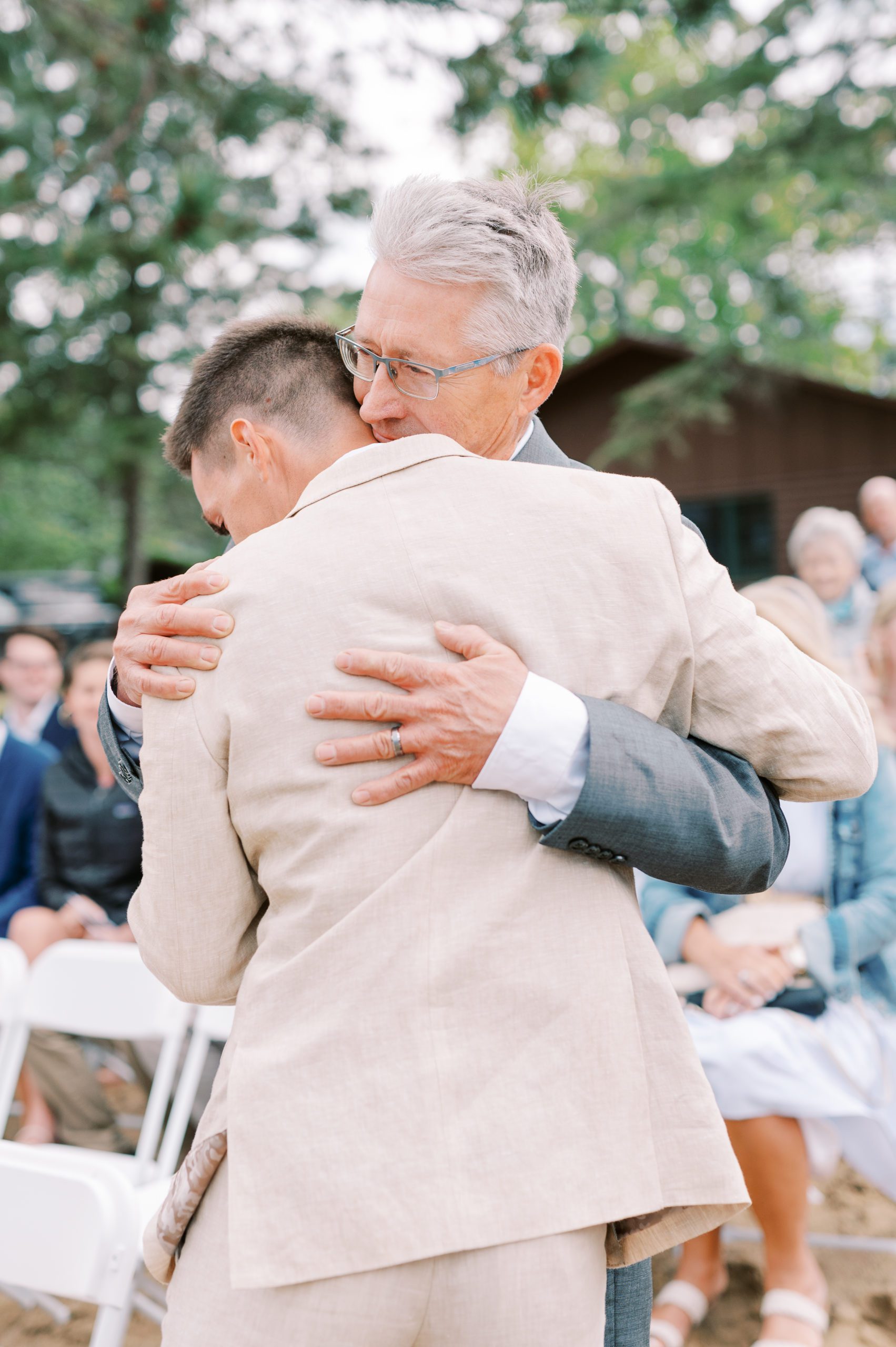 groom and dad share a hug