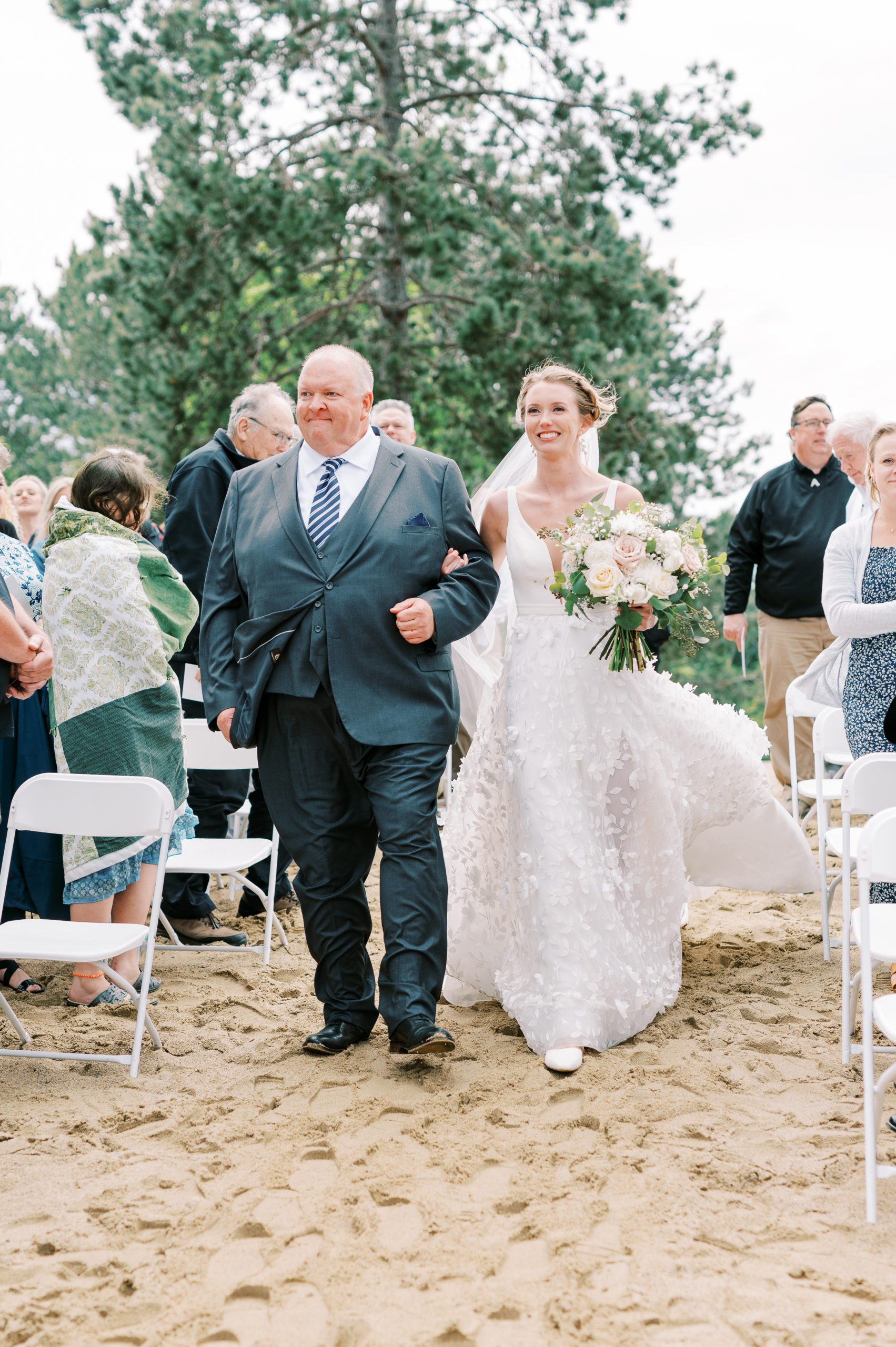 bride comes down aisle with dad