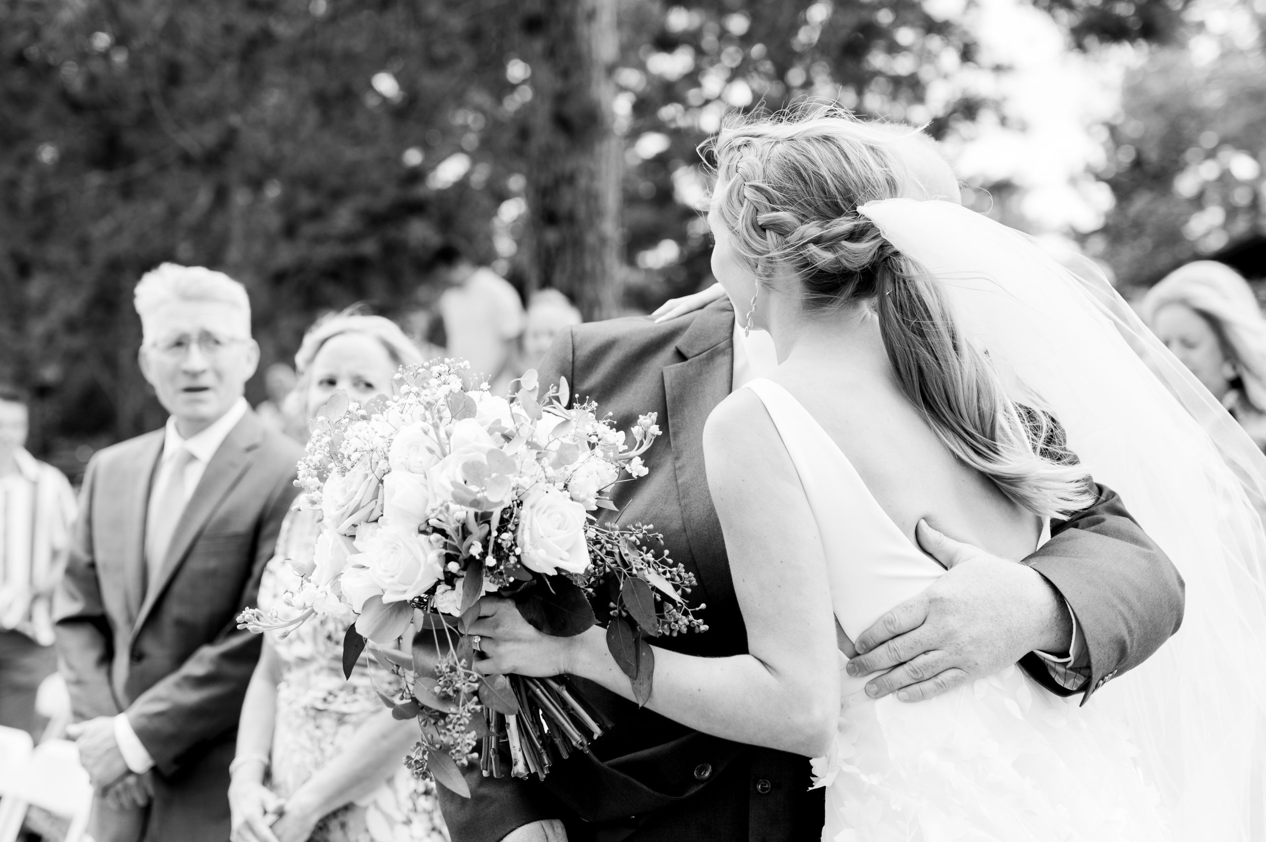 bride and dad hug at end of aisle