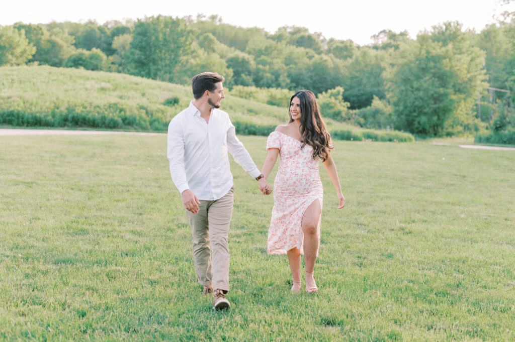 Minnesota summer maternity session couple walking together