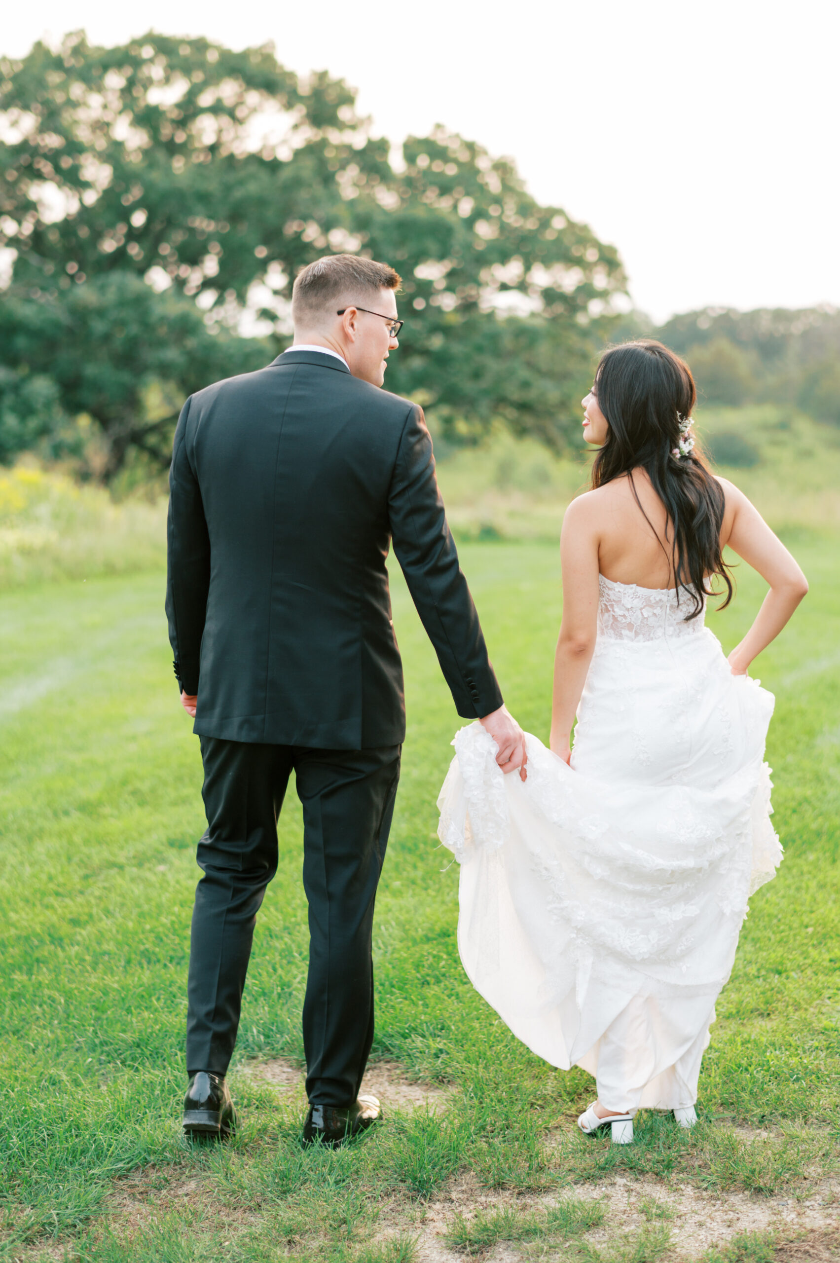 Couple walking away into the sunset at a beautiful southern Minnesota wedding.