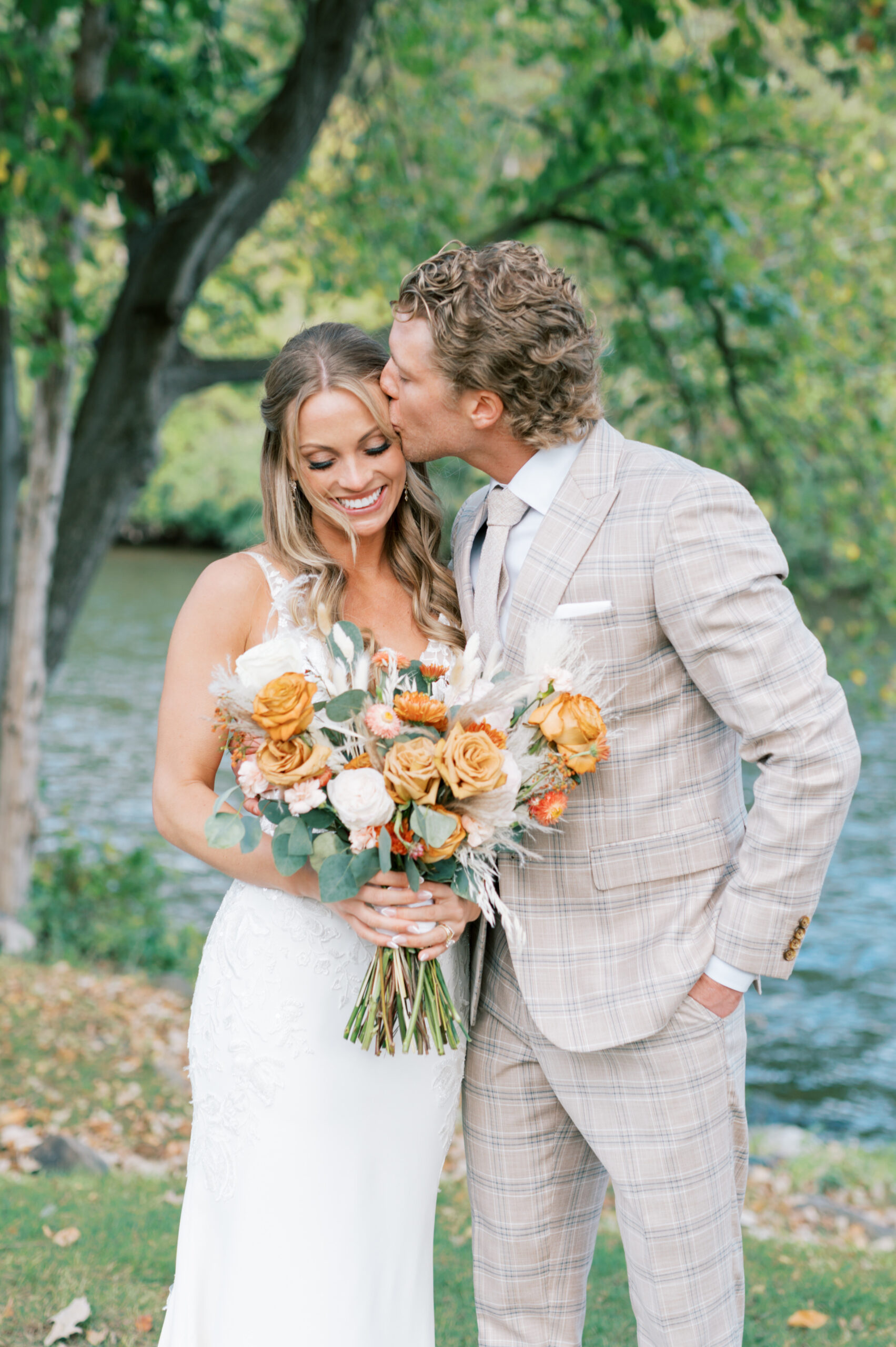 Groom kissing the bride on an autumn wedding at La Pointe Events.